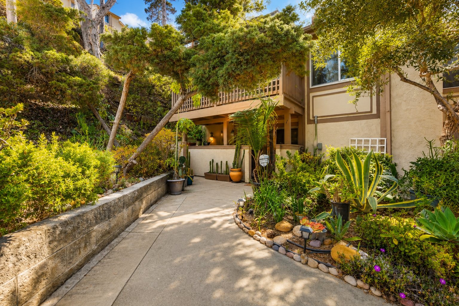 Landscaped garden walkway approaching 5430 Baltimore Drive number 1